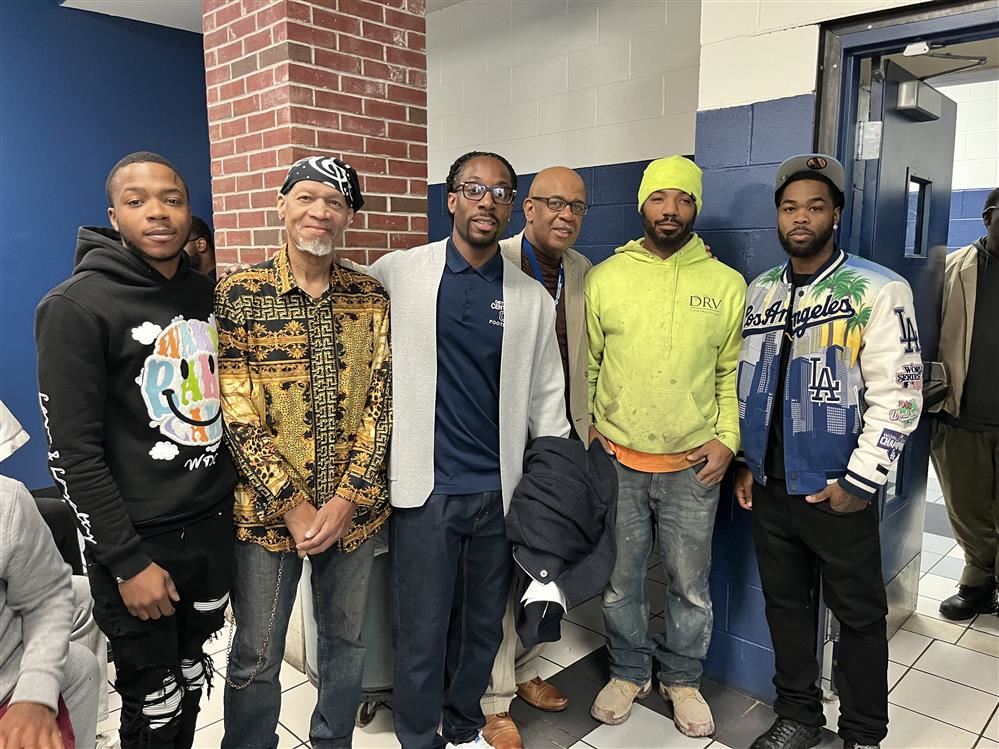  Dads and staff standing in the cafeteria